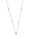 Vermeil over sterling silver necklace with four diamond shaped cz stones and an emerald shaped cz  stone in the middle.