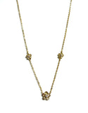 Vermeil over sterling silver chain necklace with two small cz flowers on each side and a larger cz flower in the center.