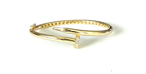 Vermeil over sterling silver bangle bracelet with a cubic zirconia nailhead in the front of the bangle.