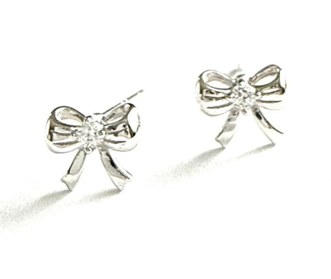 Sterling silver bow studs with a cz in the middle.