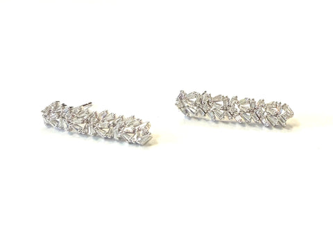 Sterling silver baguette and round staggered stone drop earrings.