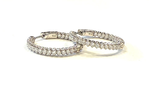 Sterling silver prong set cz inside out hoop earrings.