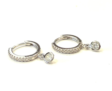 Sterling silver mini cubic zirconia huggie earring with a dangling round cz bezel.