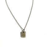 Sterling silver chain necklace with a mini dog tag pendant outlined in cubic zirconia stones.