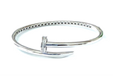 Sterling silver bangle bracelet with a cubic zirconia nailhead in the front of the bangle.