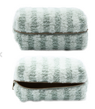 Tan striped sherpa makeup bag with a zipper closure.