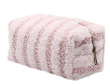 Pink striped sherpa makeup bag with a zipper closure.