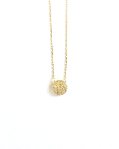 Vermeil over sterling silver cz pave disc with a hamsa in the middle of the disc.